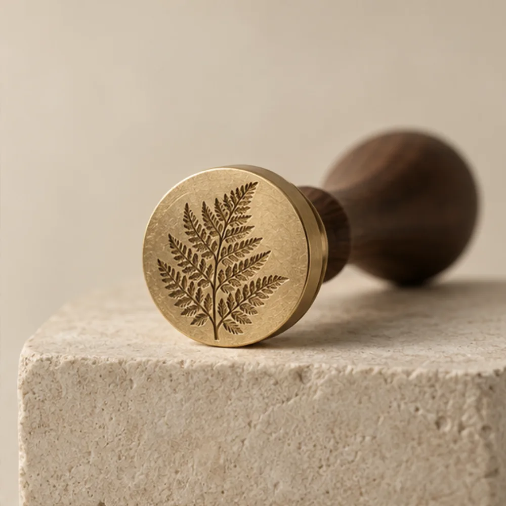 Fine fern engraving in a sculpted brass stamp
