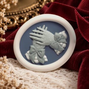 Pearl Era Gloves wax seal impression showing overlapping gloves with tiny pearl-like dots, tied bows and lace cuffs