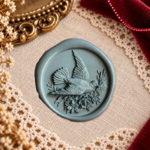 Dove and Floral Letter wax seal impression showing a flying bird carrying a letter among flowers and foliage