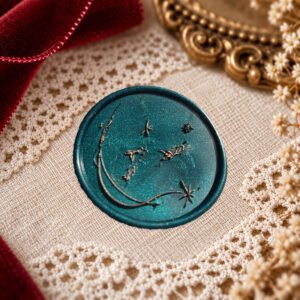 Goldfish and Stars wax seal impression showing three little goldfish, scattered stars and a sweeping curved line.